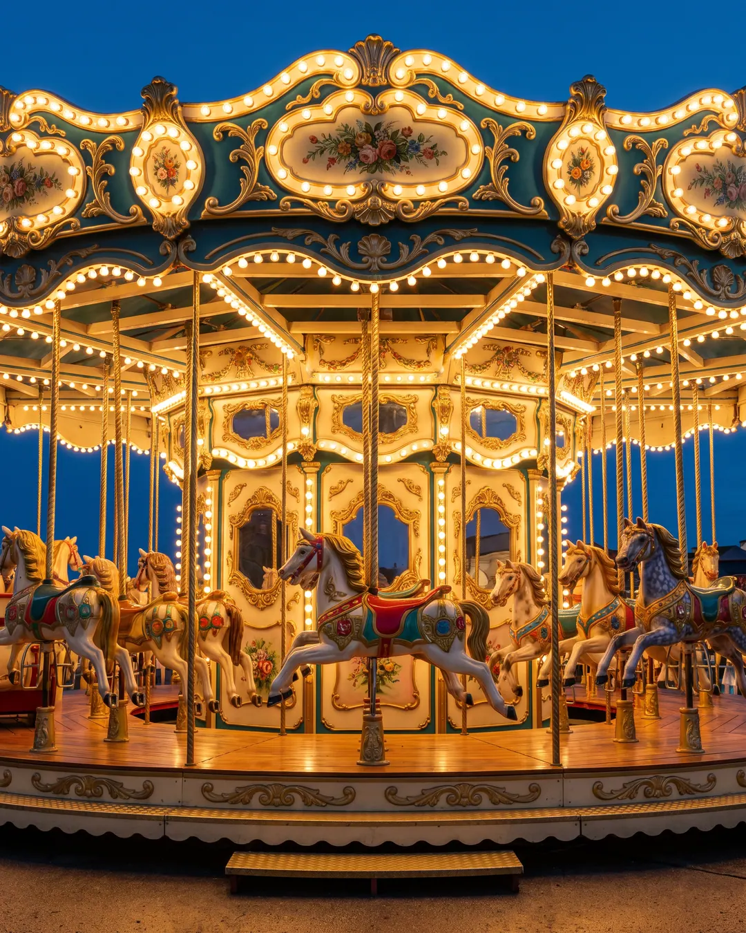 Carousel ride lit up at dusk in a family entertainment area